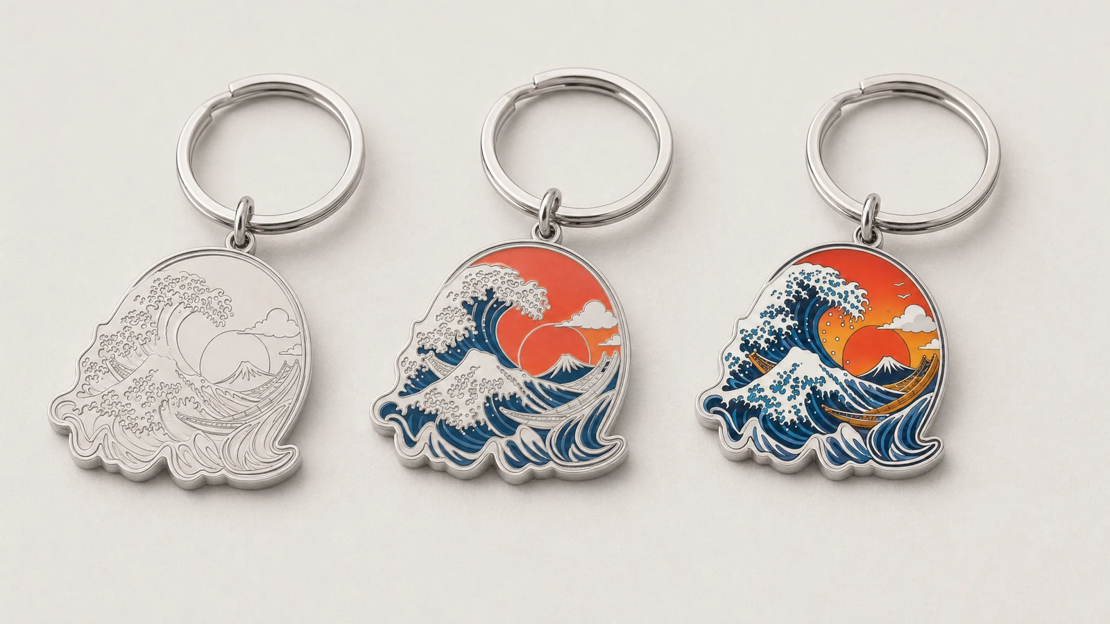 Tres llaveros con diseño de olas mostrados con relieve sin color, color parcial y arte a todo color
